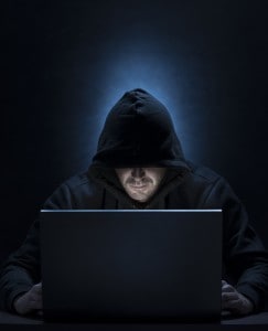 Hooded man on the computer, for hacking,spying,internet security themes
